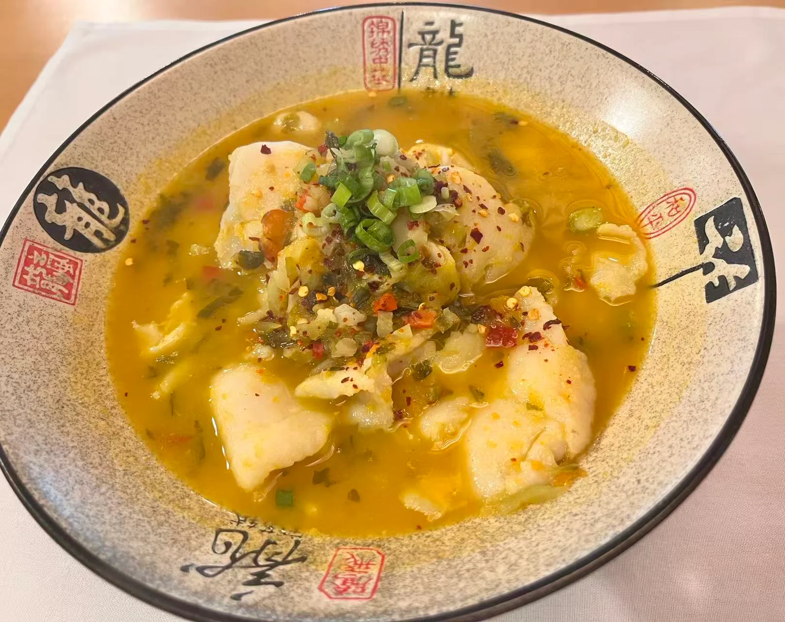 Chinese fish soup with spicy broth and herbs