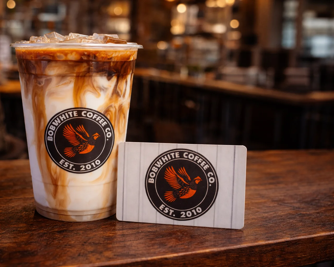 Iced coffee drink with creamy layers in a cozy café setting