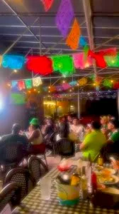 Vibrant outdoor dining area with colorful papel picado decorations