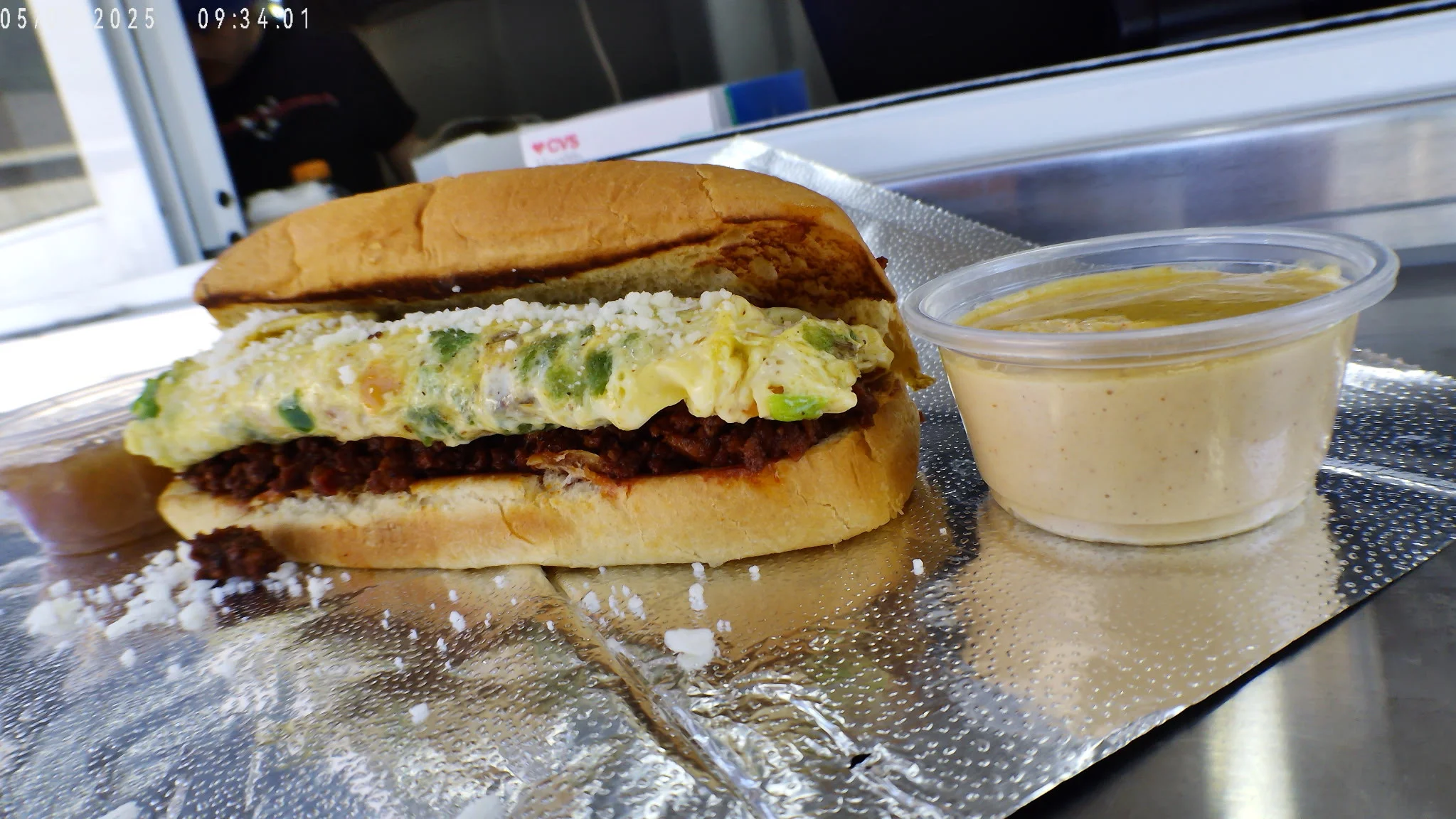 Mexican torta with chorizo and egg served with creamy sauce