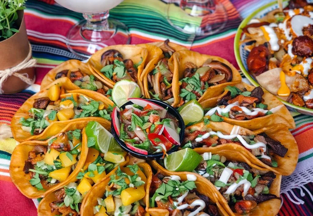 Colorful platter of Mexican tacos with margaritas on a festive table