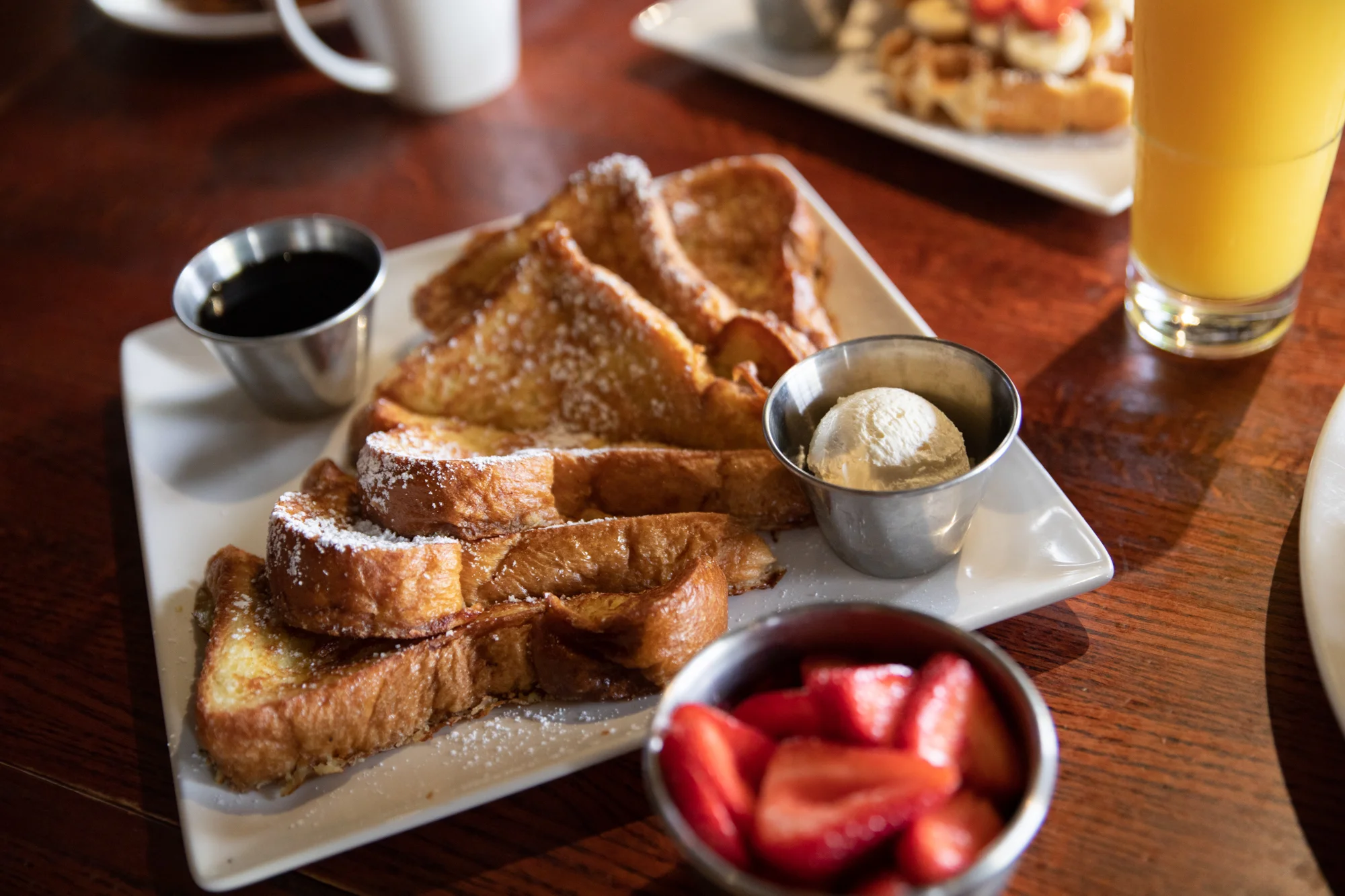 Delicious brioche French toast topped with fresh berries and syrup