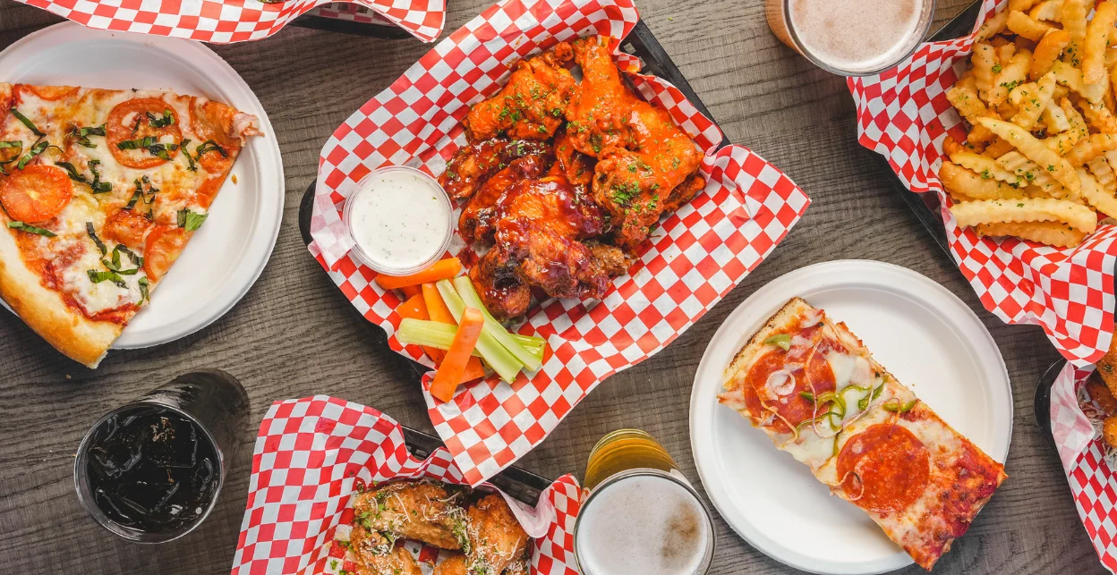 Assorted American pub food with wings and pizza