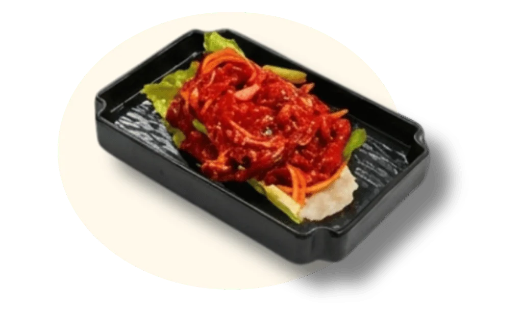 A dish featuring spicy red sauce with vegetables on a lettuce leaf.