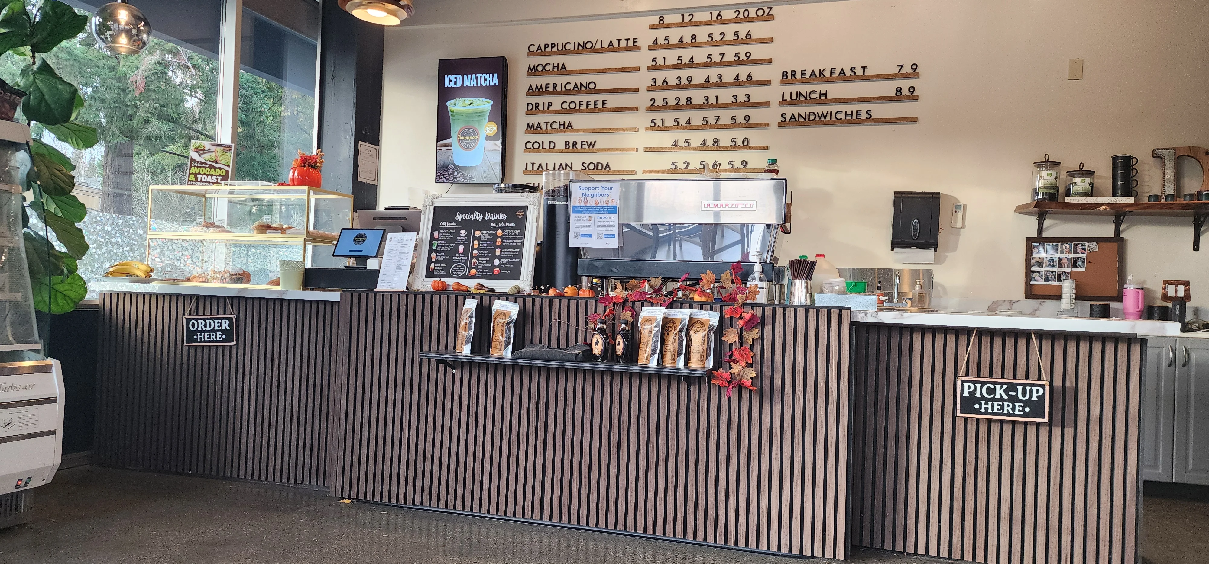 Cozy café counter with menu and pastries on display