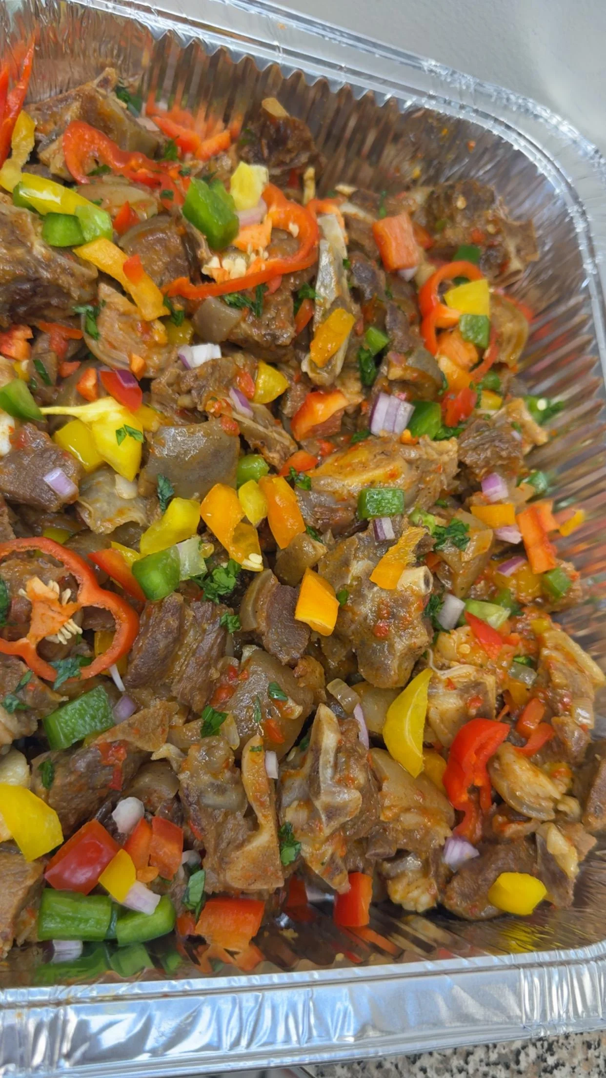 Jamaican oxtail stew with colorful peppers