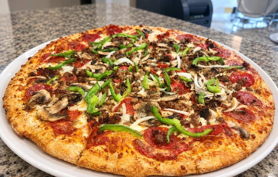 Hawaiian-style pizza with pineapple and chicken on a metal tray