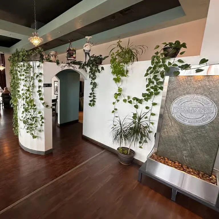 Elegant restaurant entrance with greenery and water feature