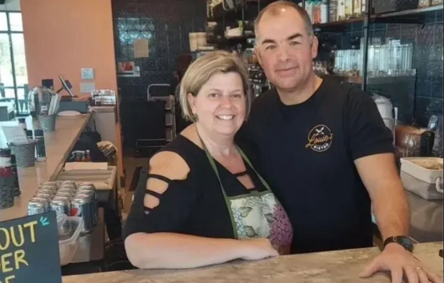 Friendly staff posing at the bar of a cozy restaurant