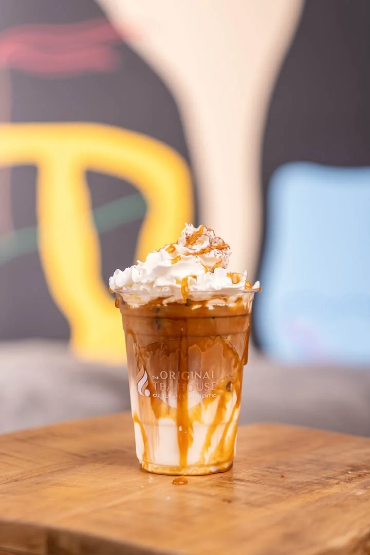 Iced caramel macchiato topped with whipped cream