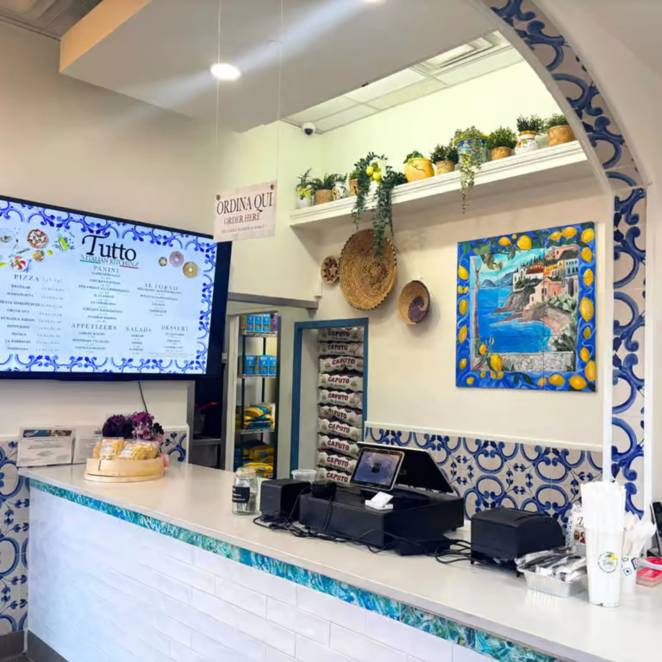 Entrance of Tutto restaurant with welcoming ambiance and signage.