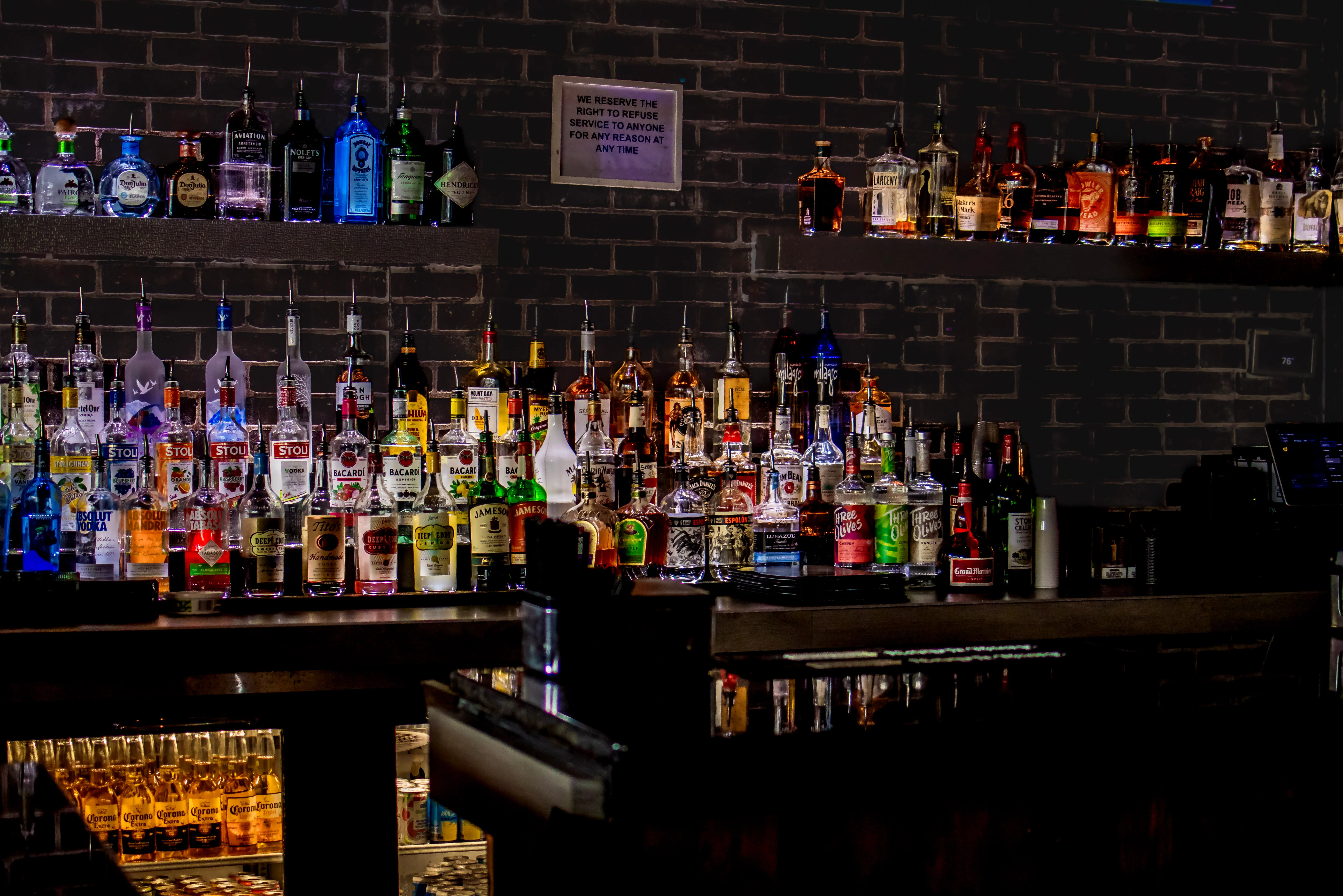Well-stocked bar with various liquor bottles on display