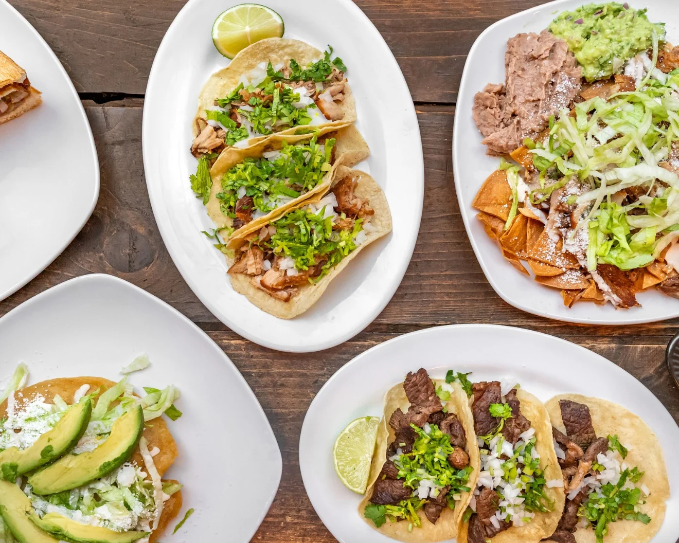 Authentic Mexican tacos with various toppings and sides
