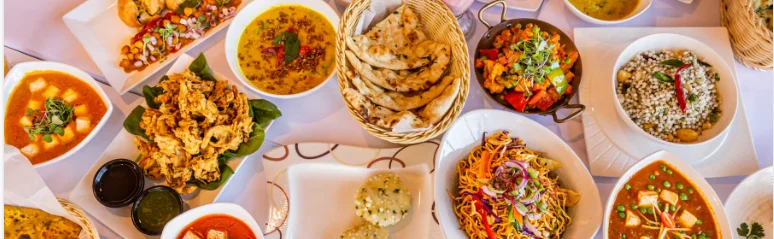 Assorted Indian dishes including naan, curry, and biryani