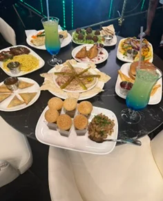 Assorted Indian dishes including samosas and biryani on a dining table