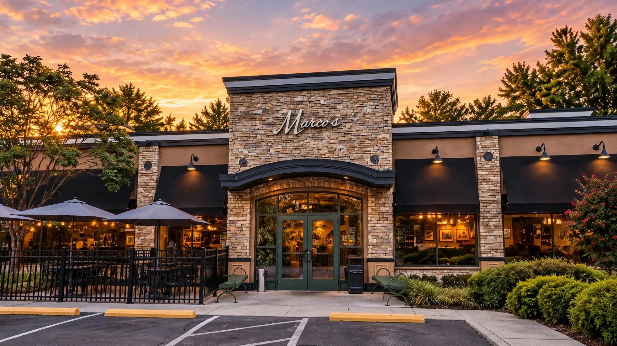 Marco's restaurant exterior with stone facade and outdoor patio at sunset