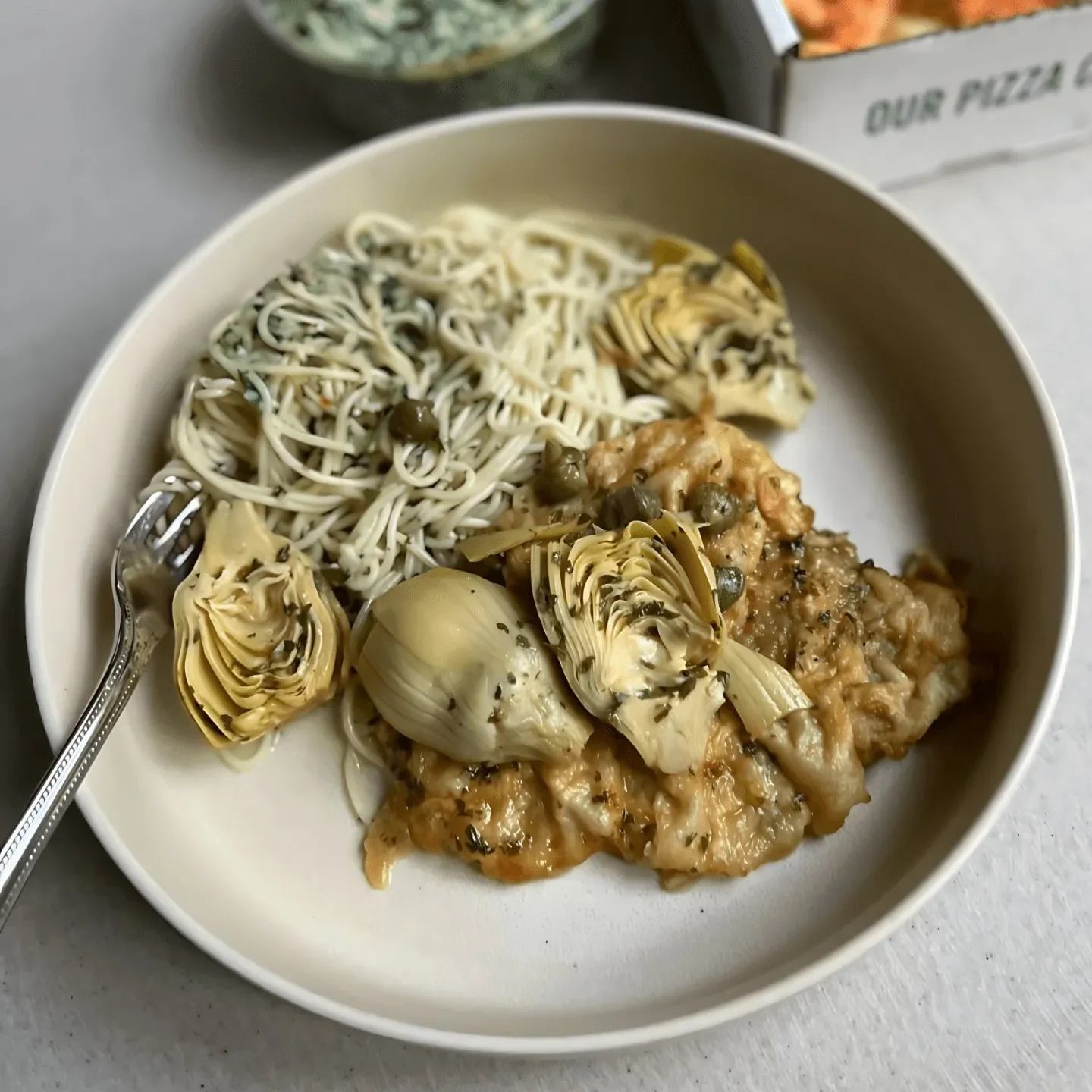 Creamy chicken piccata with artichokes and pasta