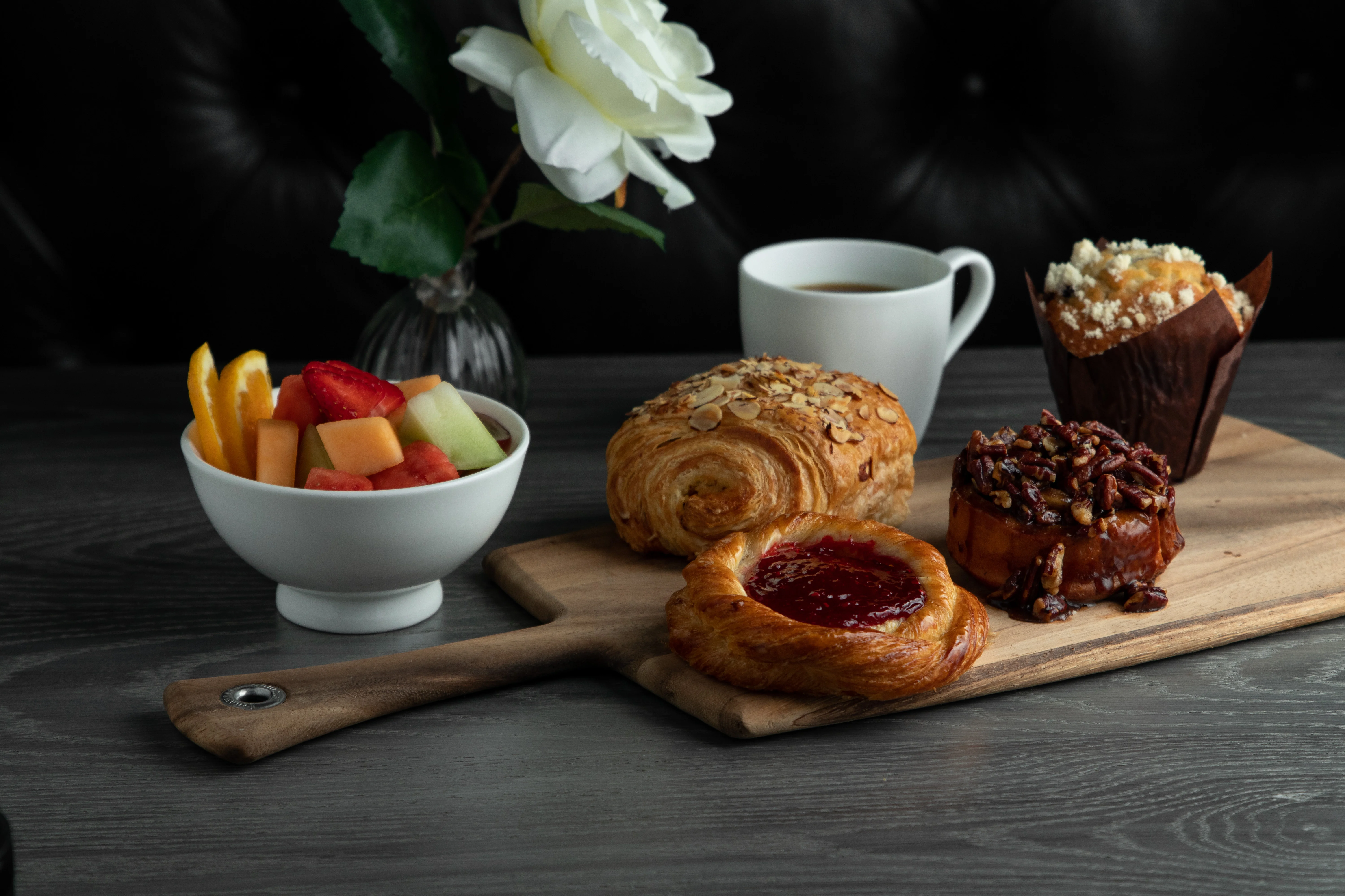 A variety of fresh baguettes displayed on a wooden board.