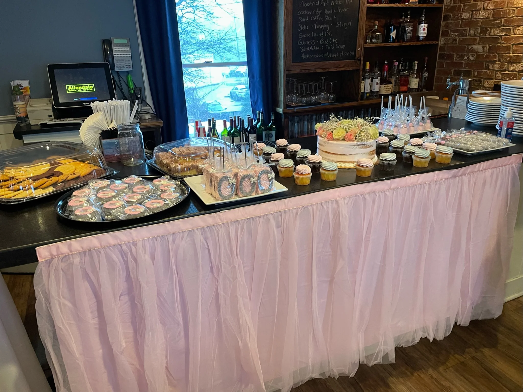 Dessert table with assorted cupcakes and a beautiful cake