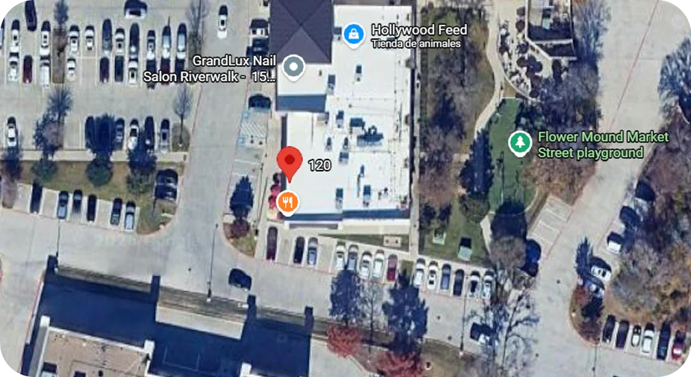 Aerial view of a shopping area with parking and playground