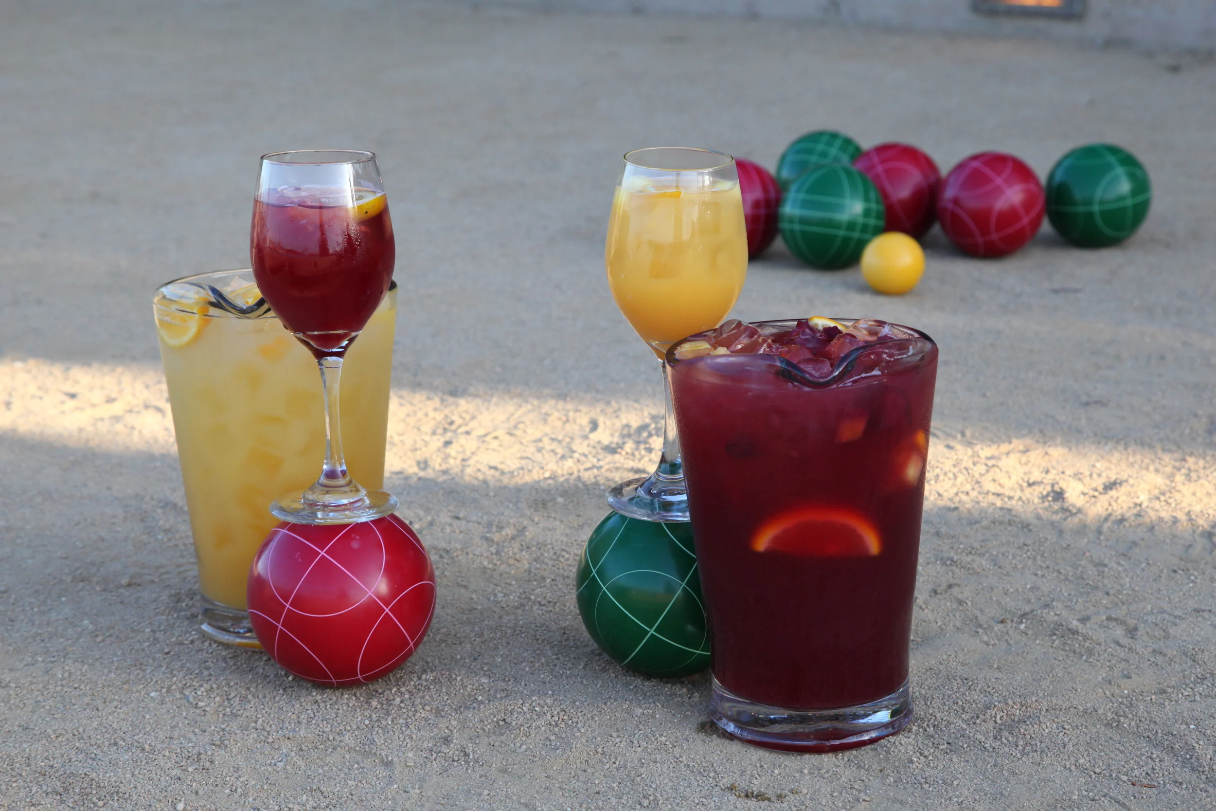 cocktails balanced on bocce balls