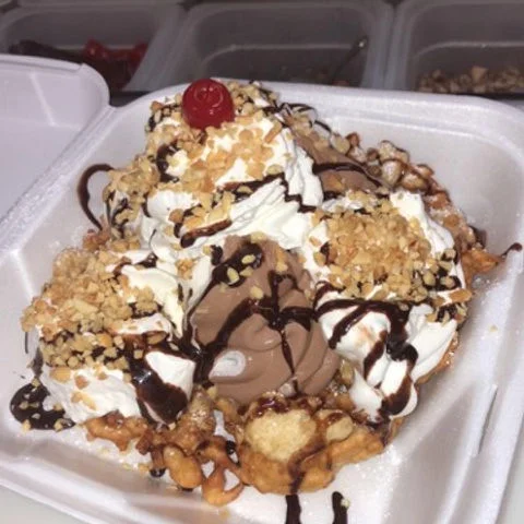 Decadent funnel cake sundae with chocolate ice cream