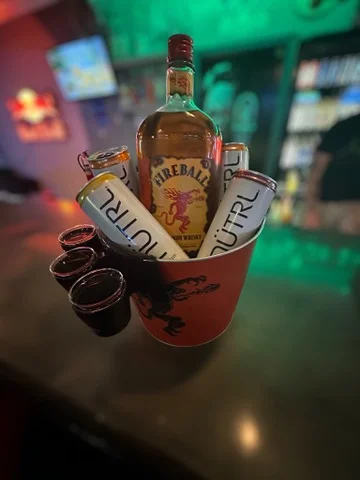 Chilled drinks in a bucket at a lively bar