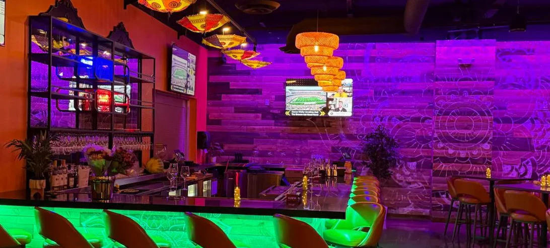 Vibrant bar interior with colorful lighting and modern decor