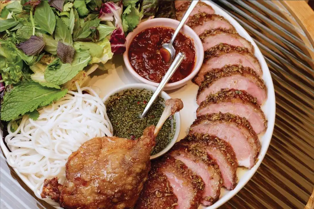 SMOKED DRY AGED DUCK. Crispy Leg Confit, Duck XO Sauce, Rice Noodles, Lettuce Wraps, Nước Mắm Chimichurri