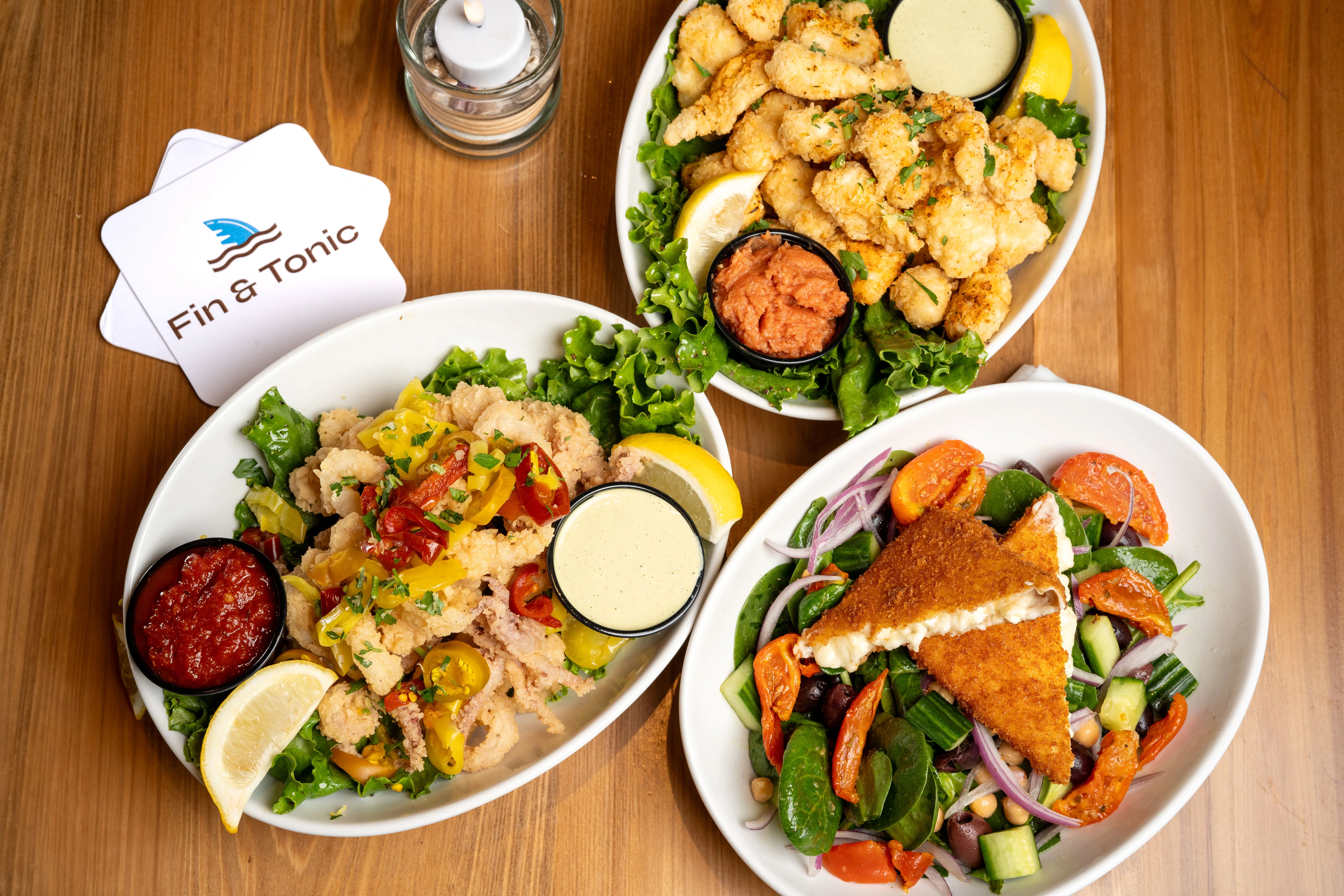 Fried calamari and Mediterranean salad in a vibrant restaurant setting