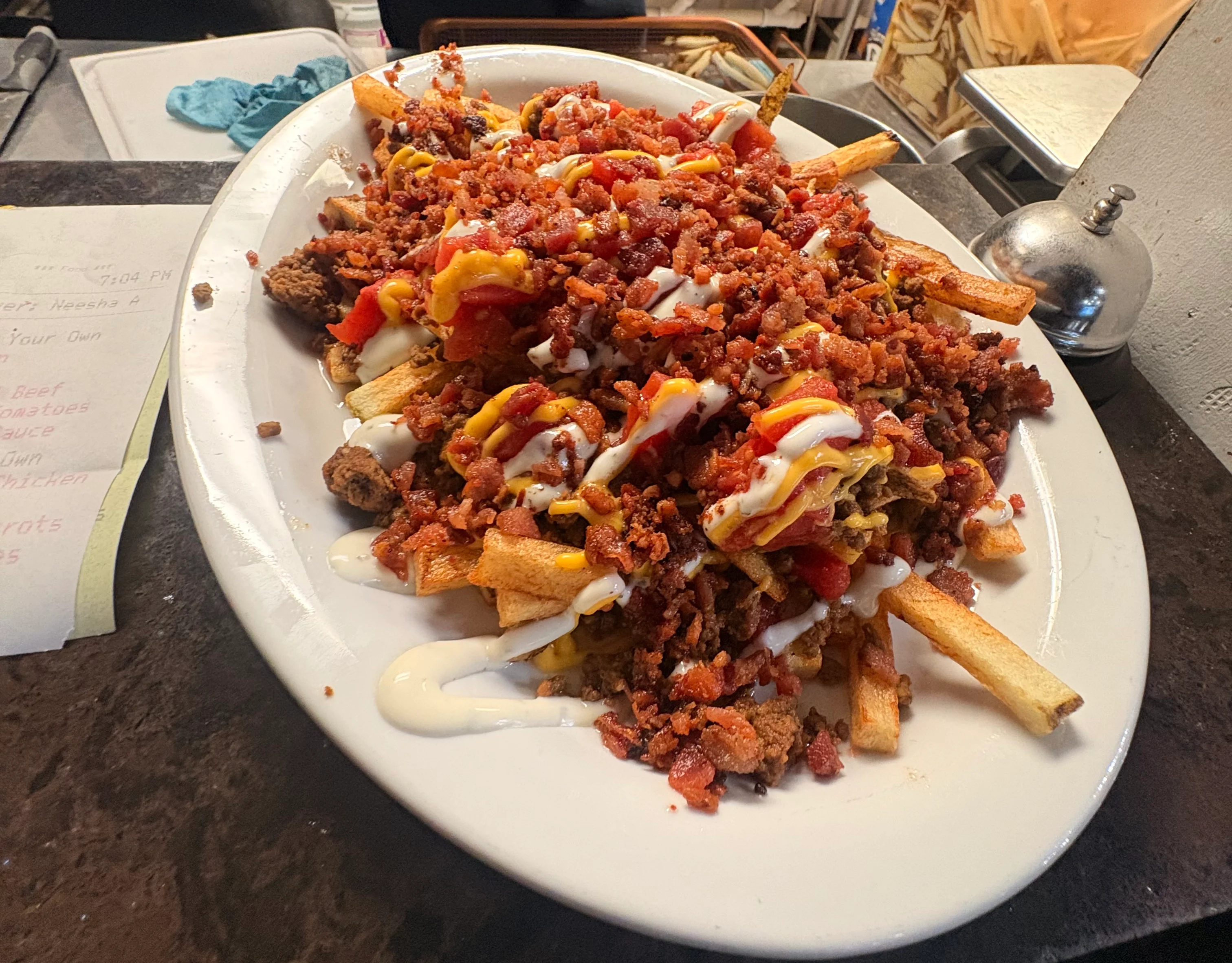 Loaded nachos topped with meat and sauces, a popular comfort food dish