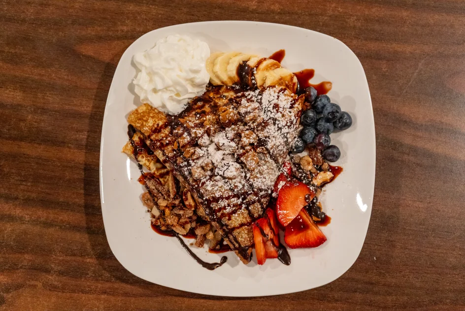 Decadent dessert crepes with fruit and whipped cream