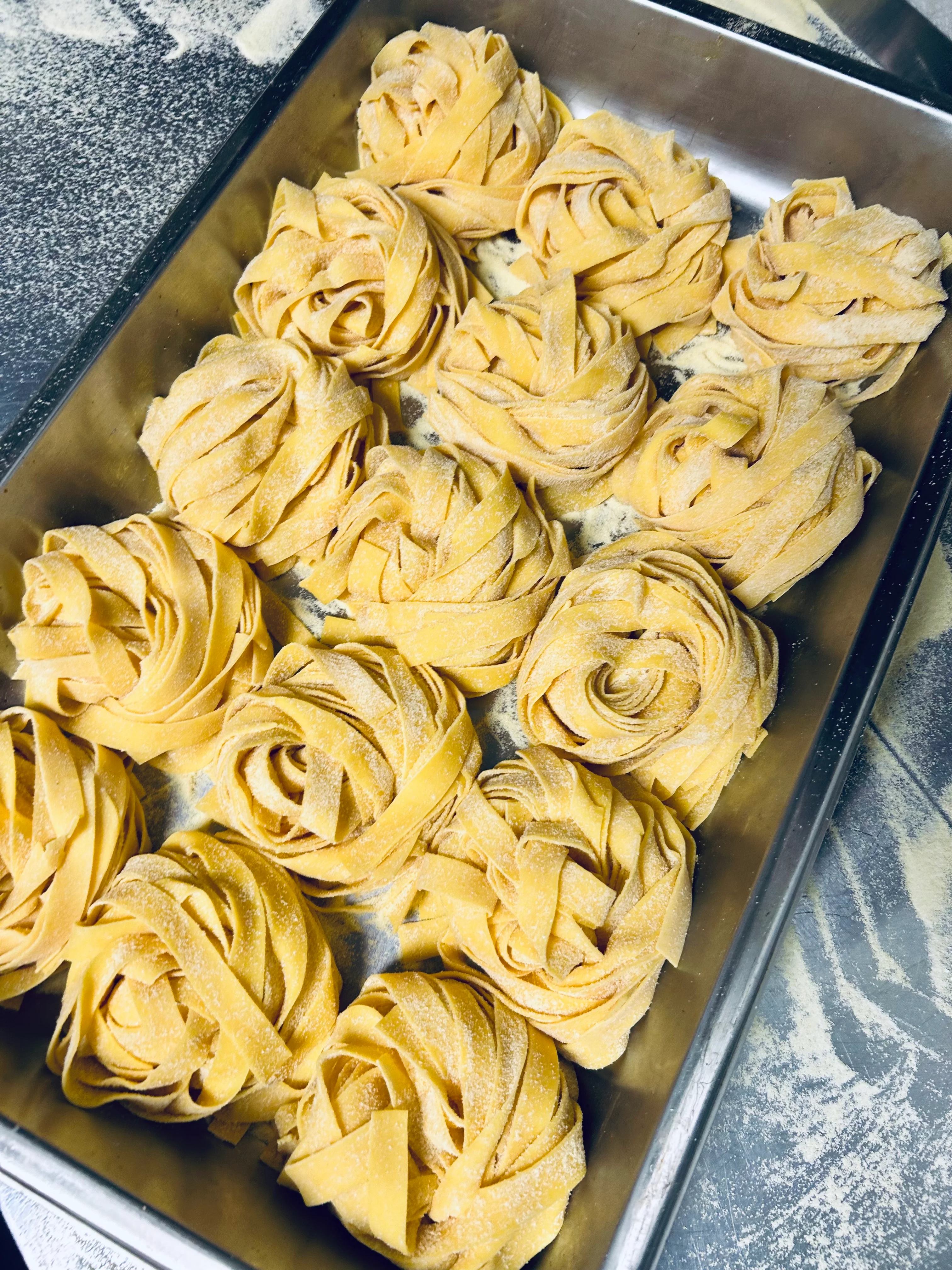 Freshly made fettuccine pasta nests ready for cooking