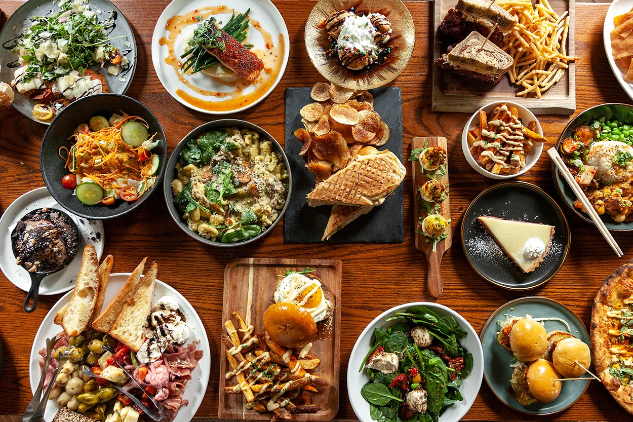 Variety of global dishes including pasta, salads, and desserts