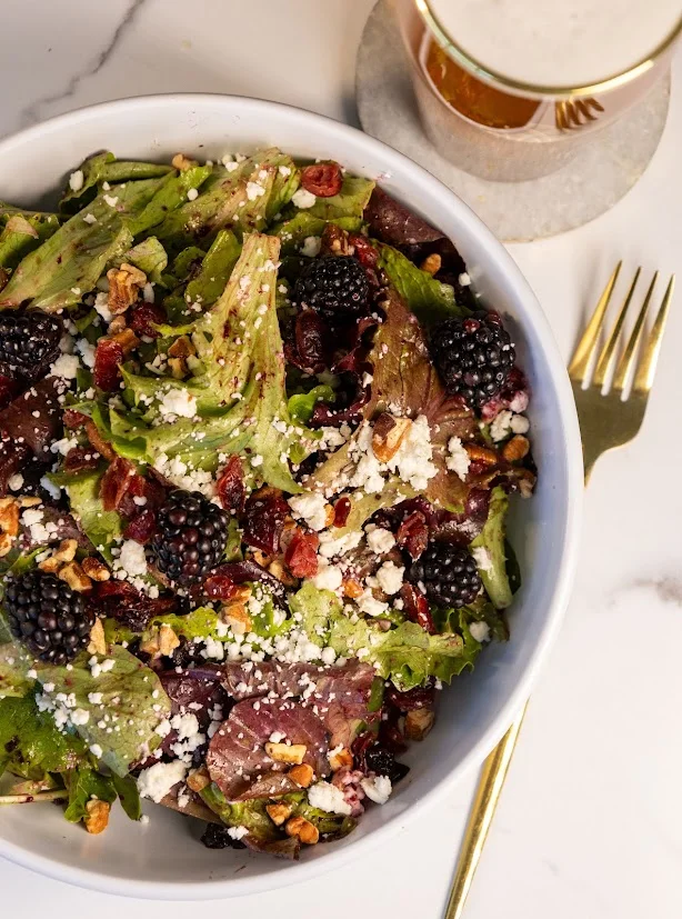 Fresh mixed greens salad with blackberries and feta