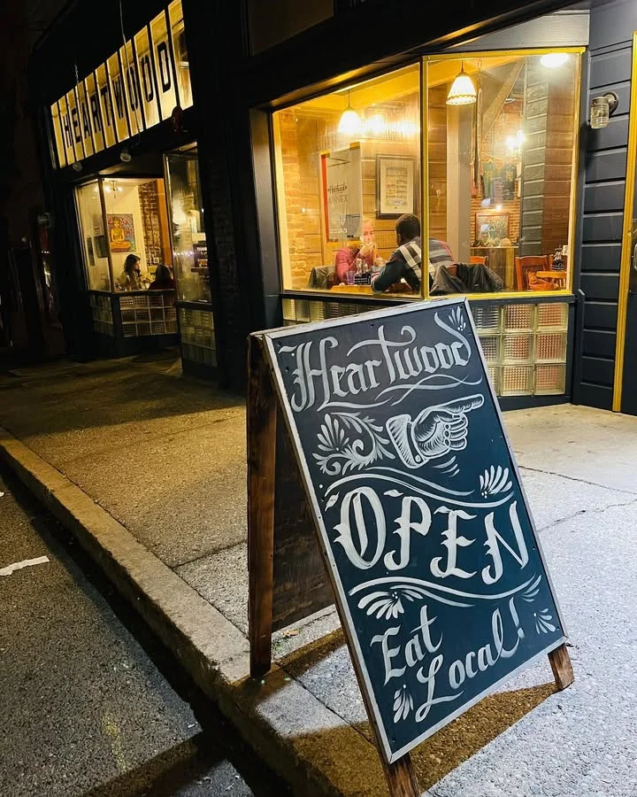Charming restaurant exterior with open sign and warm lighting