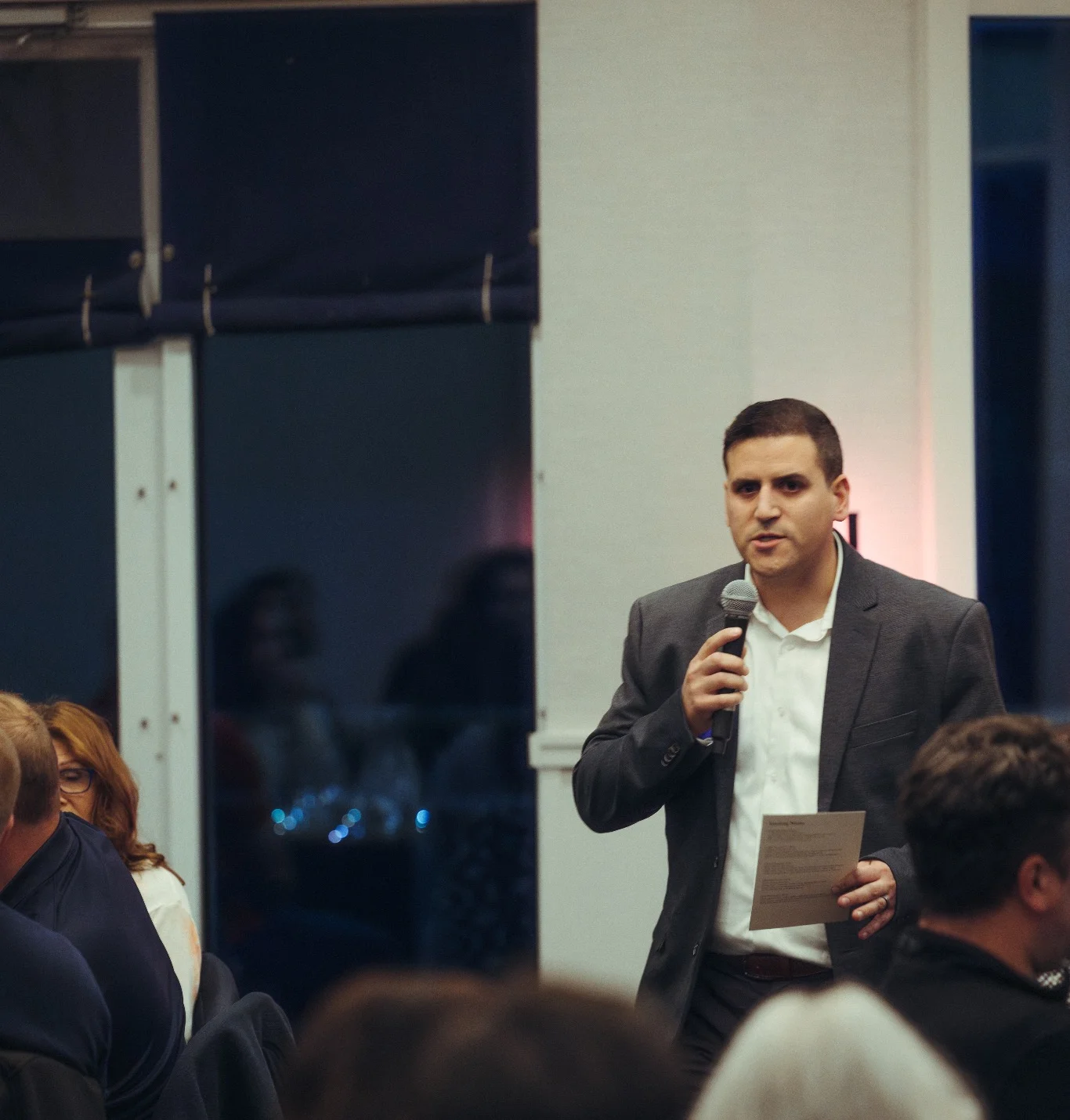 Speaker addressing an audience at a formal event