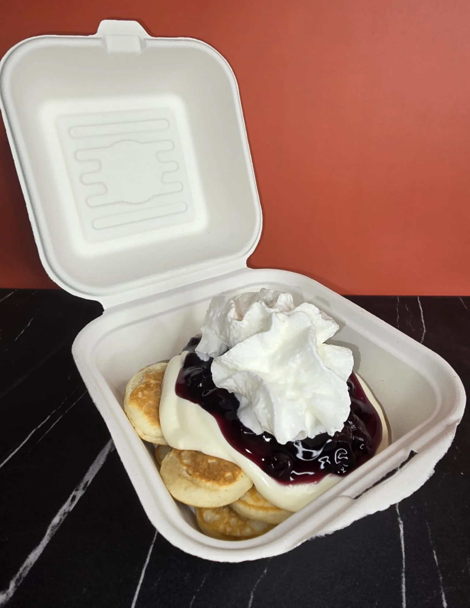 Fluffy Japanese pancakes with whipped cream and berry sauce