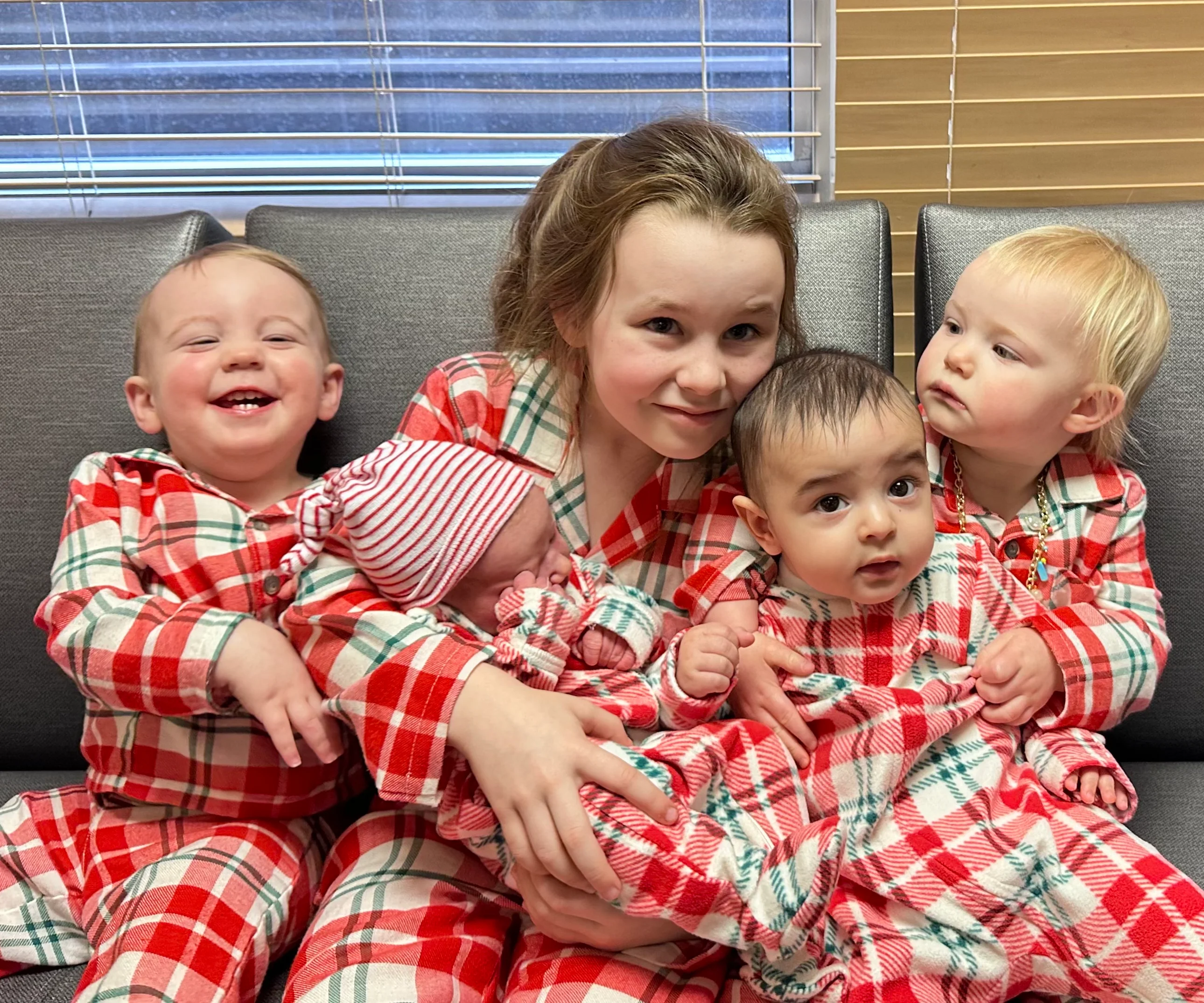 Children in matching festive pajamas smiling together