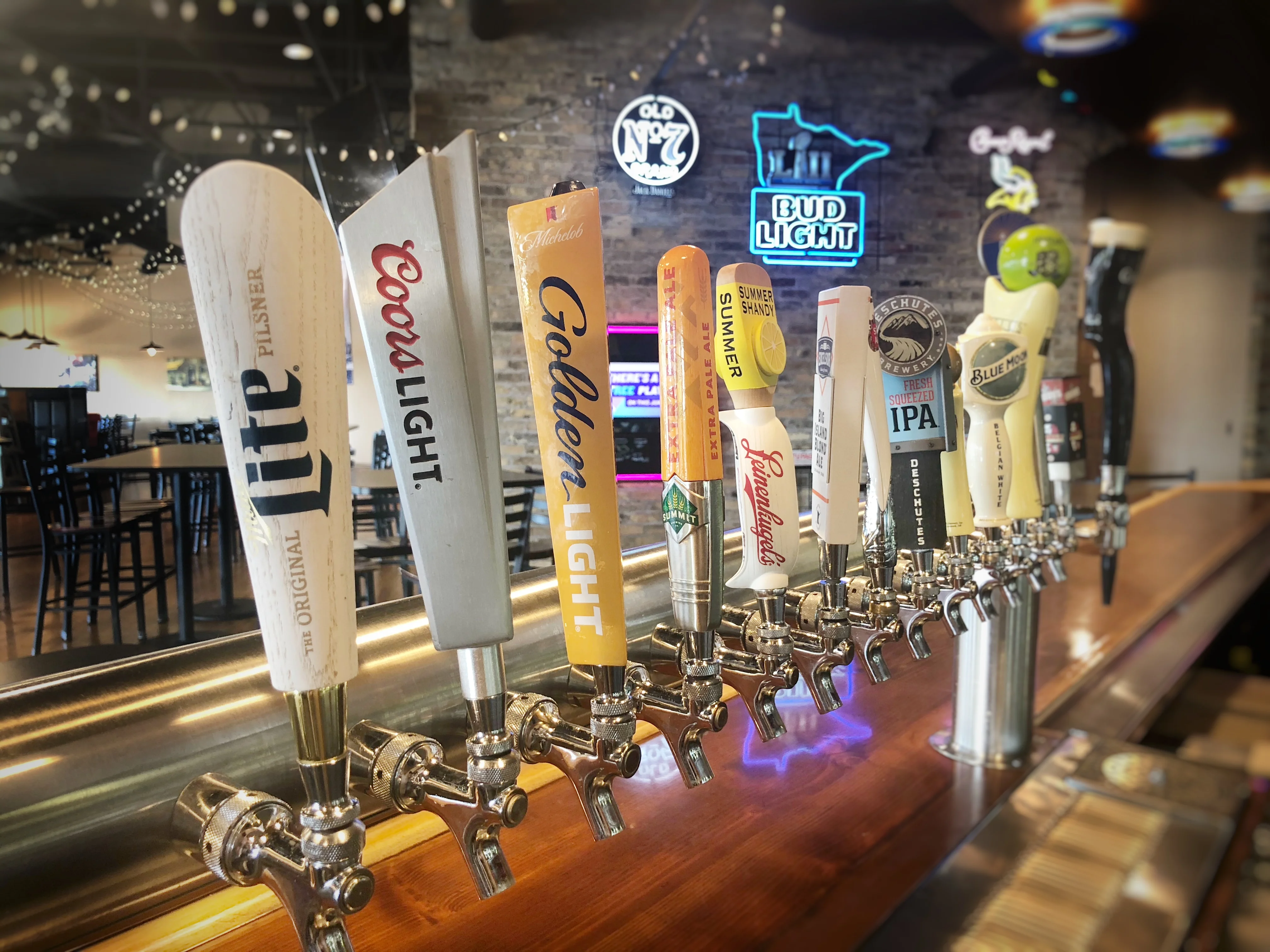 Variety of beer taps at a lively bar