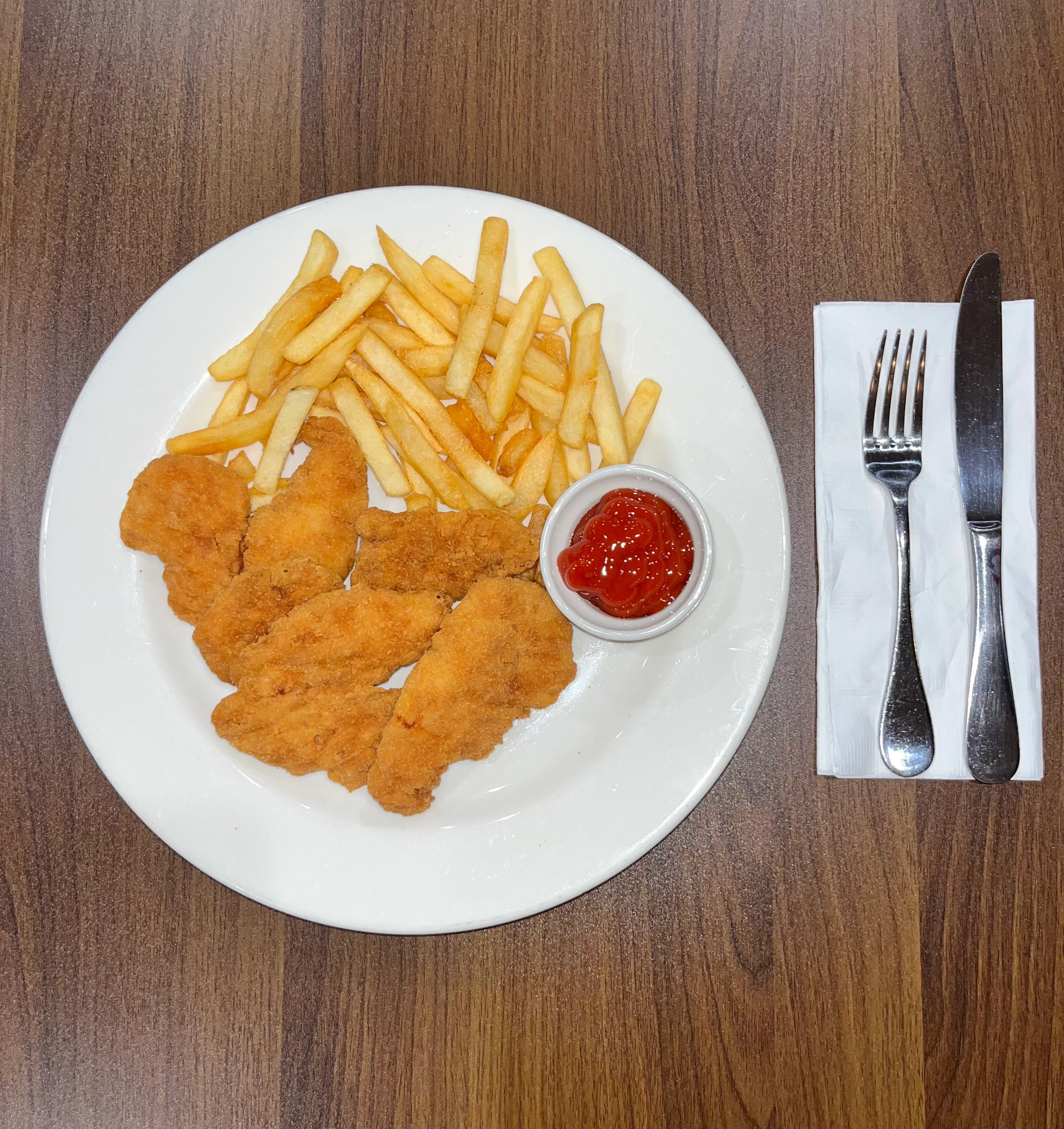 Crispy chicken tenders with fries and ketchup