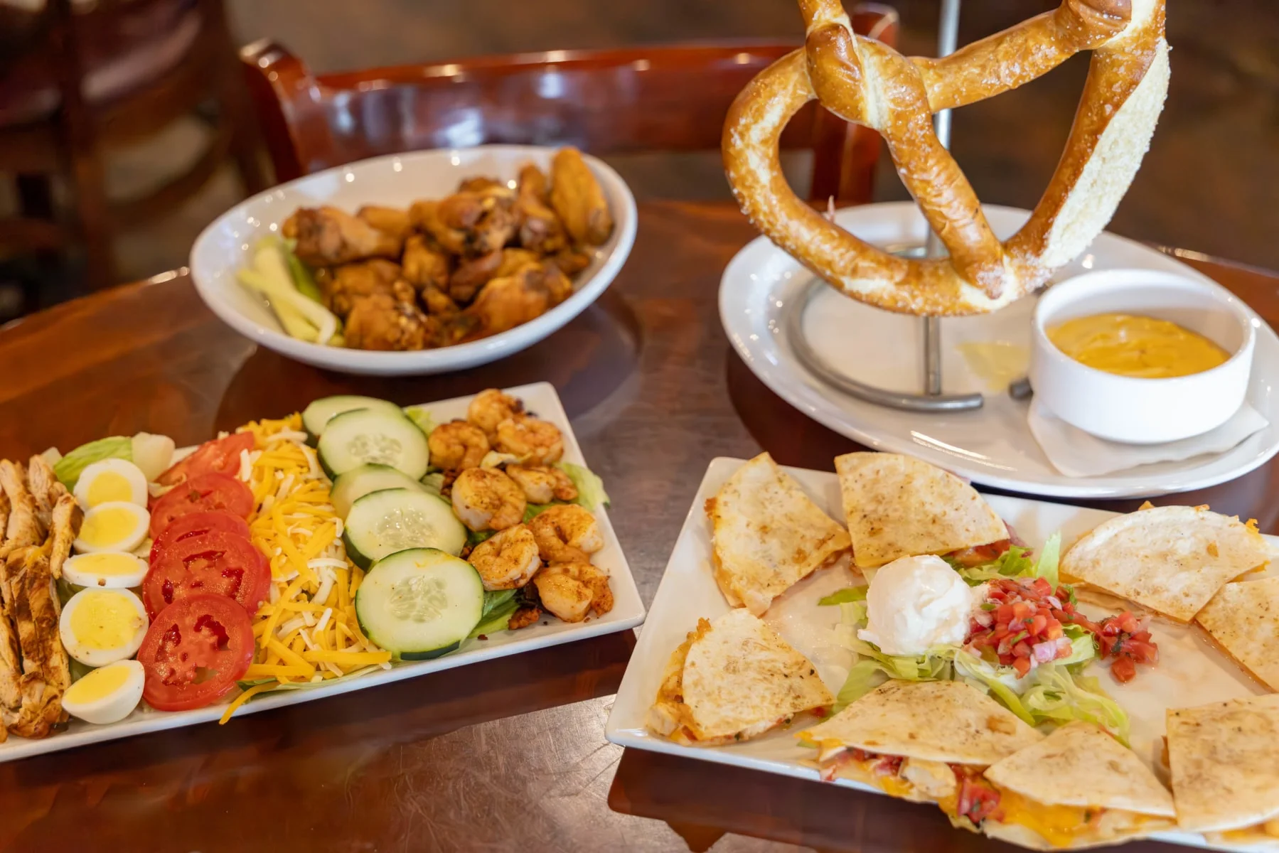 Appetizing American-style appetizer platter with wings and quesadillas