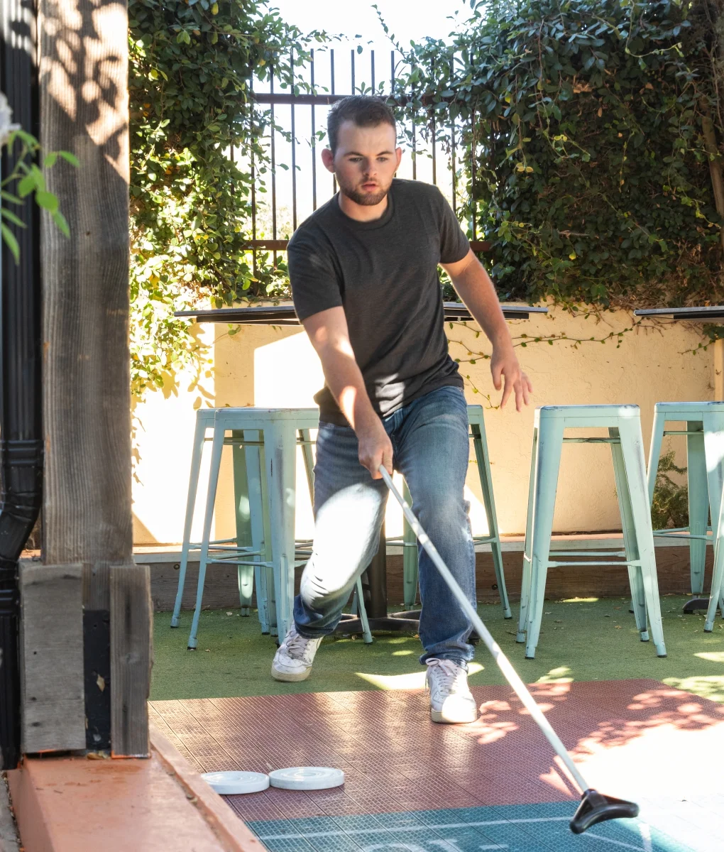 Man playing shuffleboard