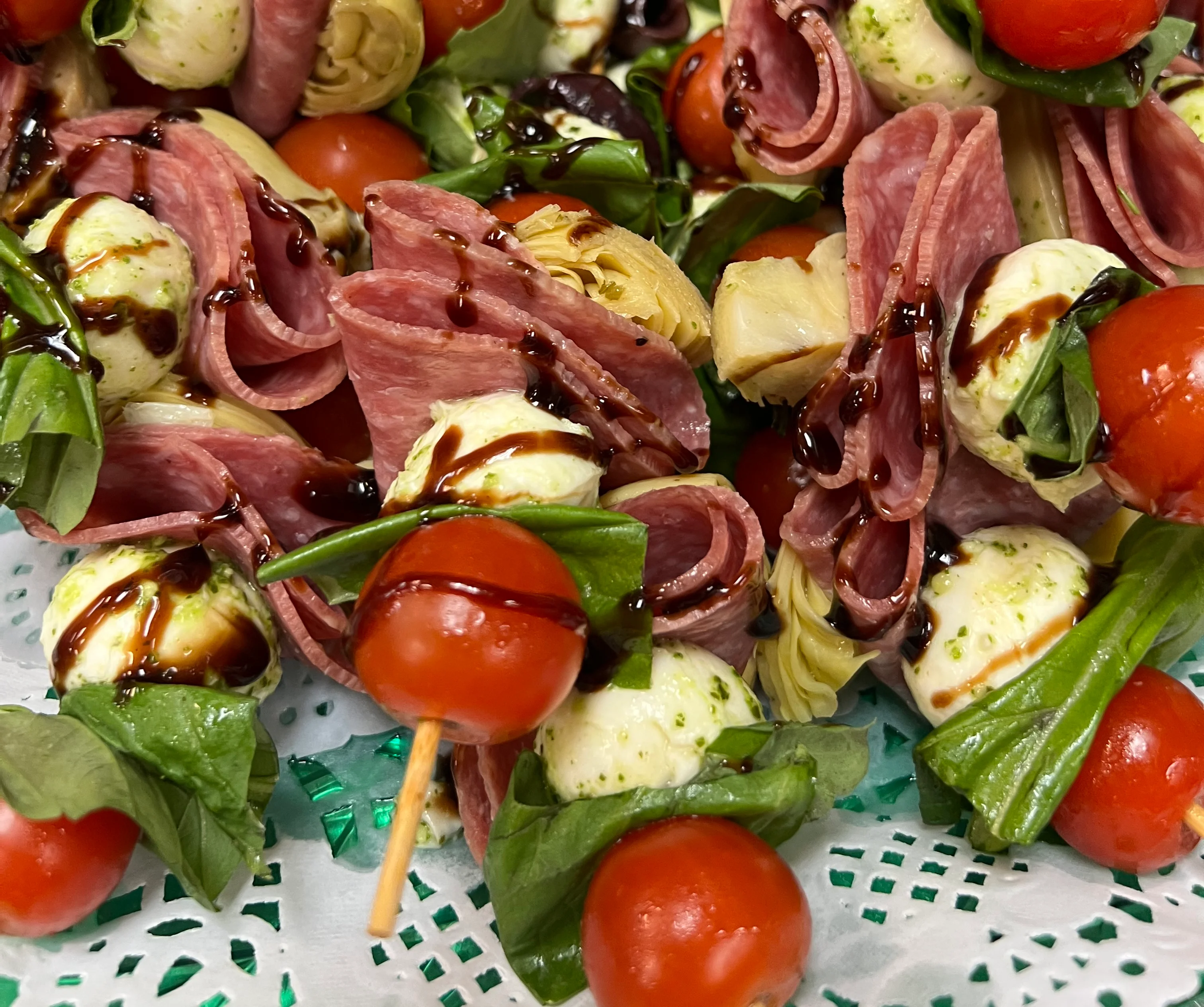 Italian antipasto skewers with fresh vegetables, mozzarella, olives, and cured meat