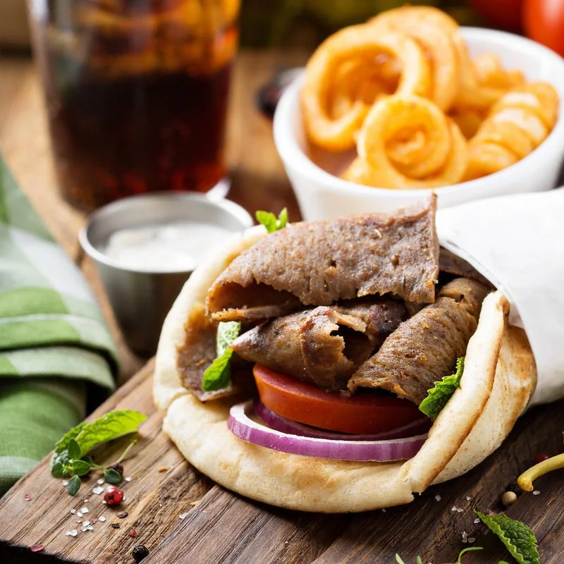 Delicious gourmet burger with fresh toppings on a wooden table