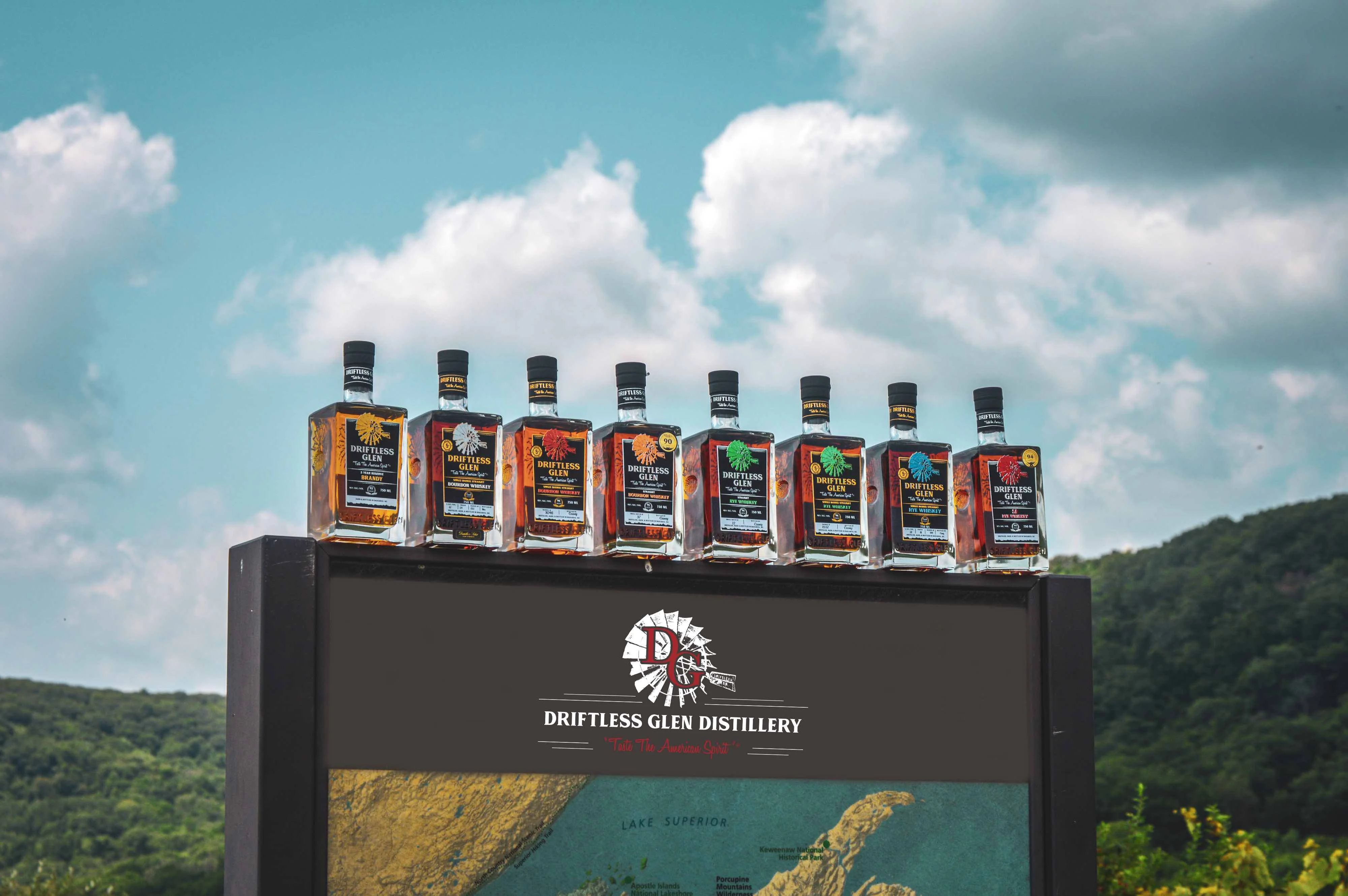 Driftless Glen spirits lined up with a blue sky behind