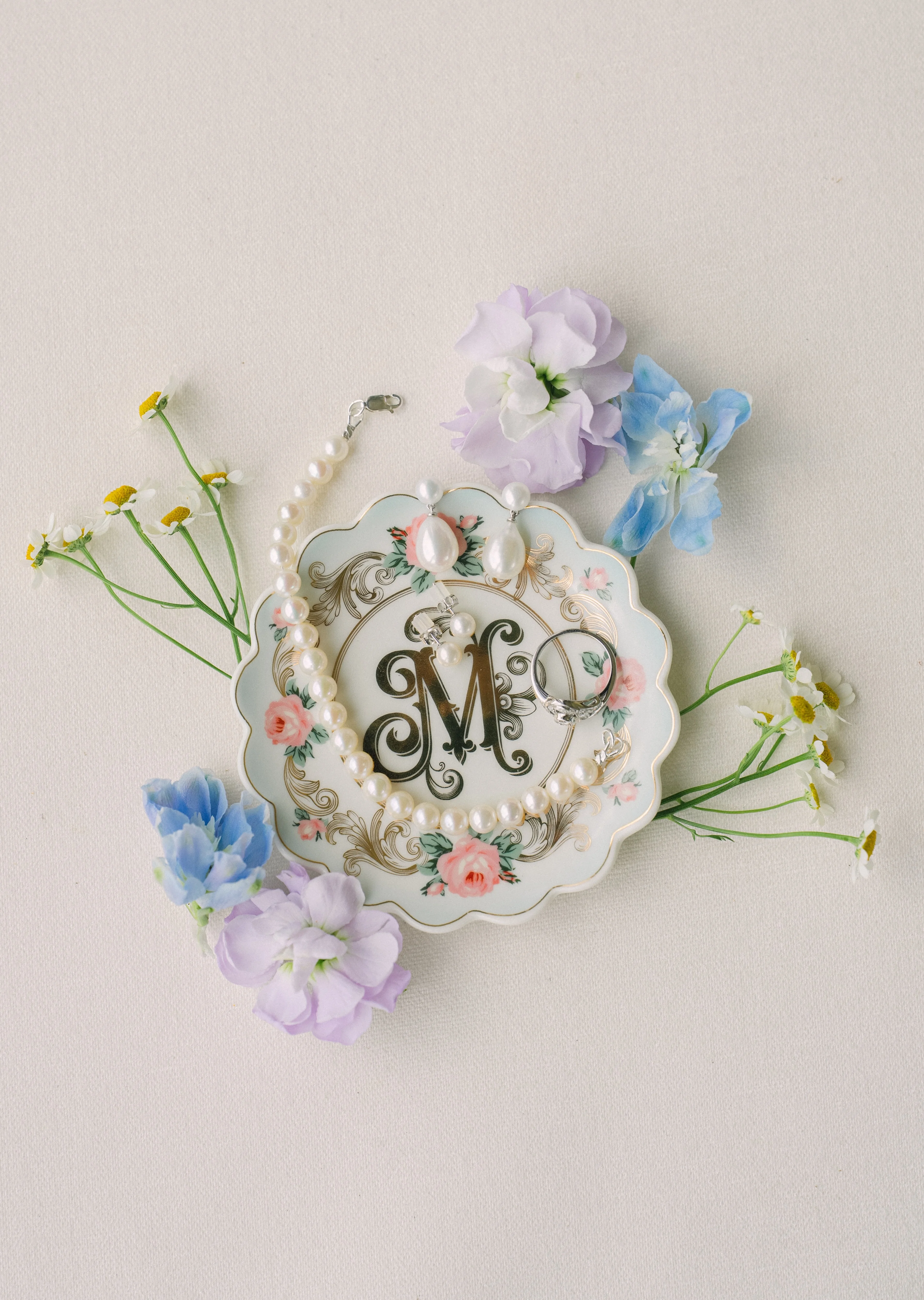 Elegant jewelry display on a floral plate