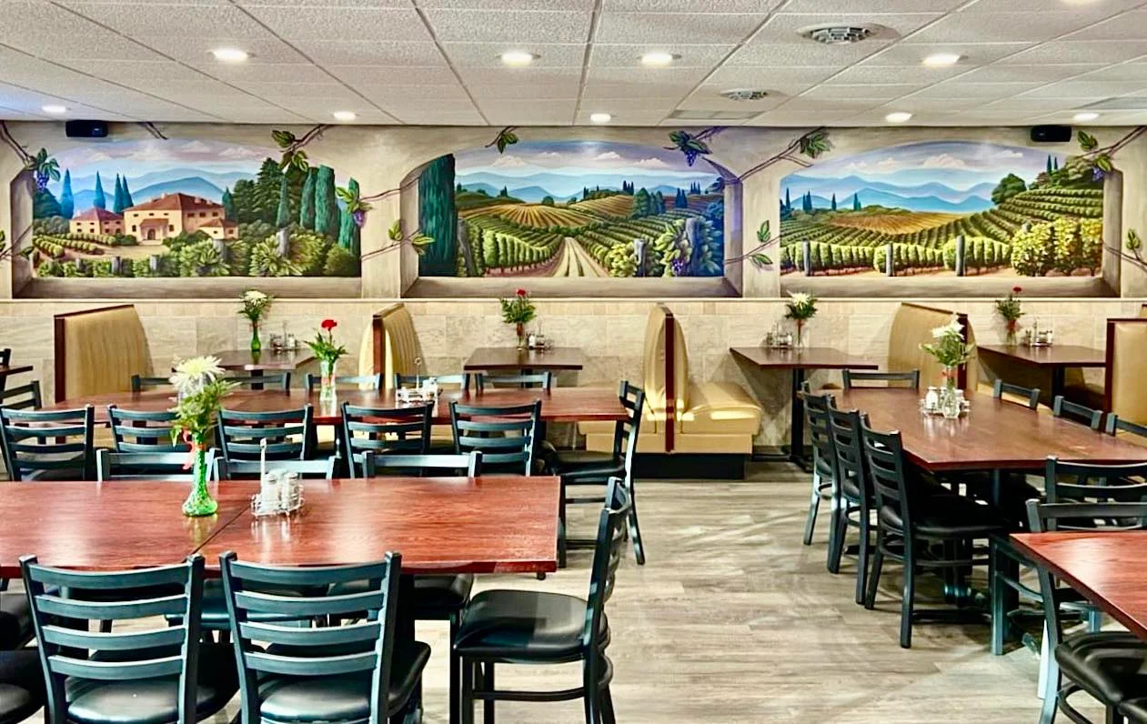 Charming restaurant interior with vineyard mural