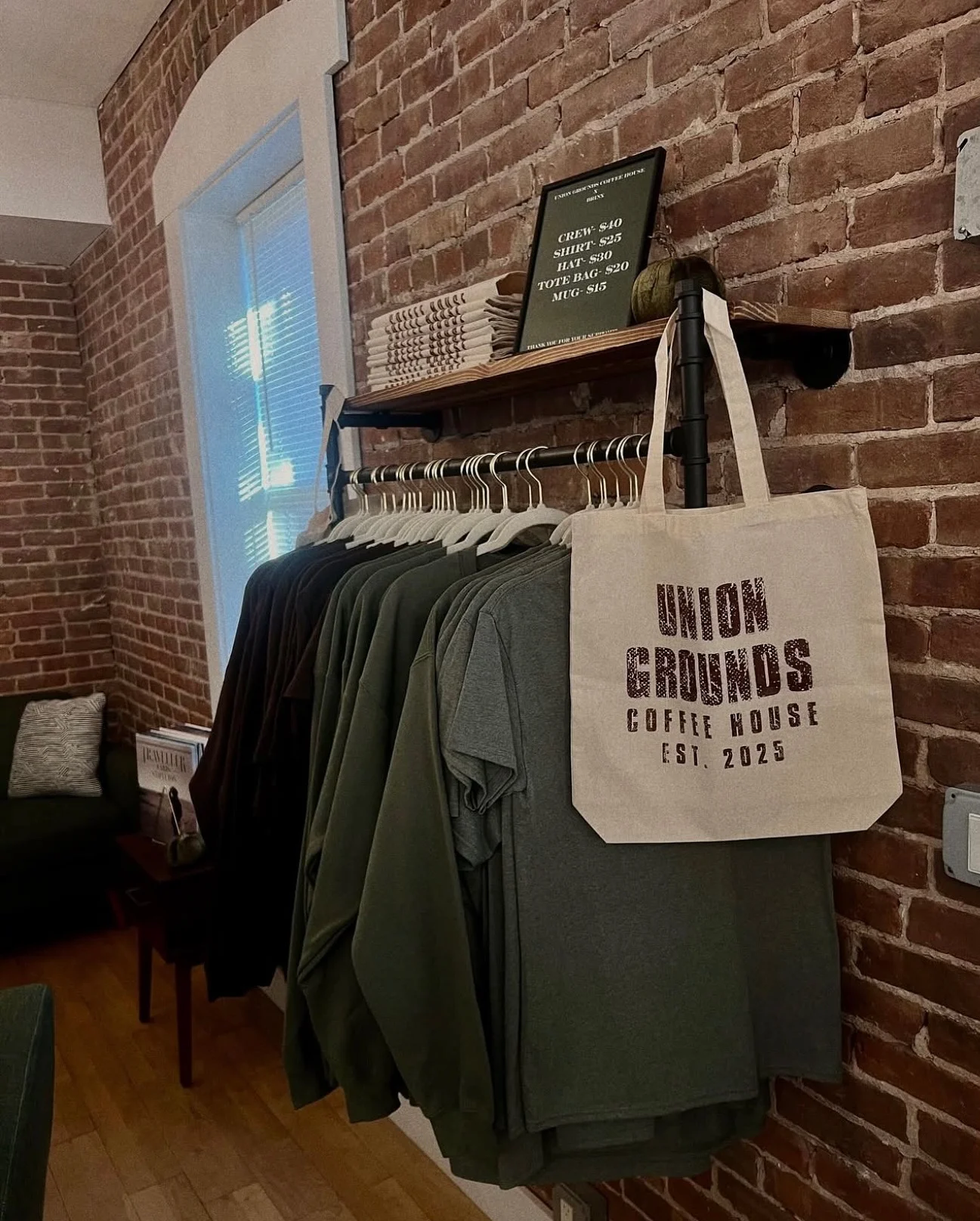 Merchandise display at Union Grounds Coffee House with apparel and tote bags