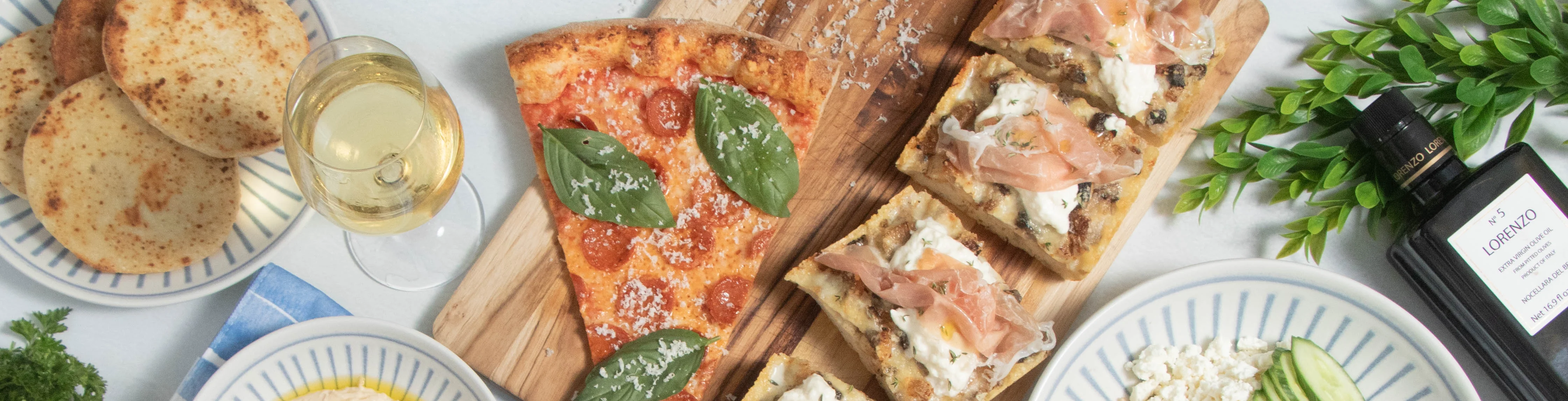 Mediterranean mezze platter with grilled chicken and pizza